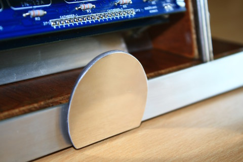Close-up on the aluminium front structure. The circular decoration has a very high polishing.