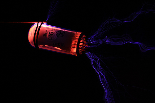 Click for a high-resolution version. Nixie tube vs. Tesla coil